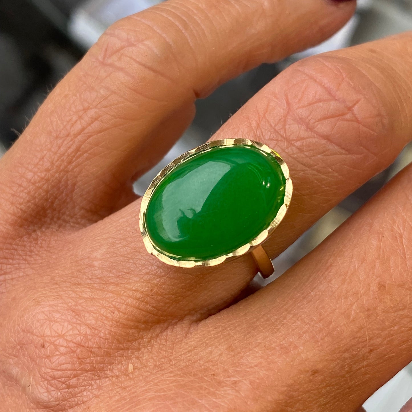 Jade ring with gold setting on a hand