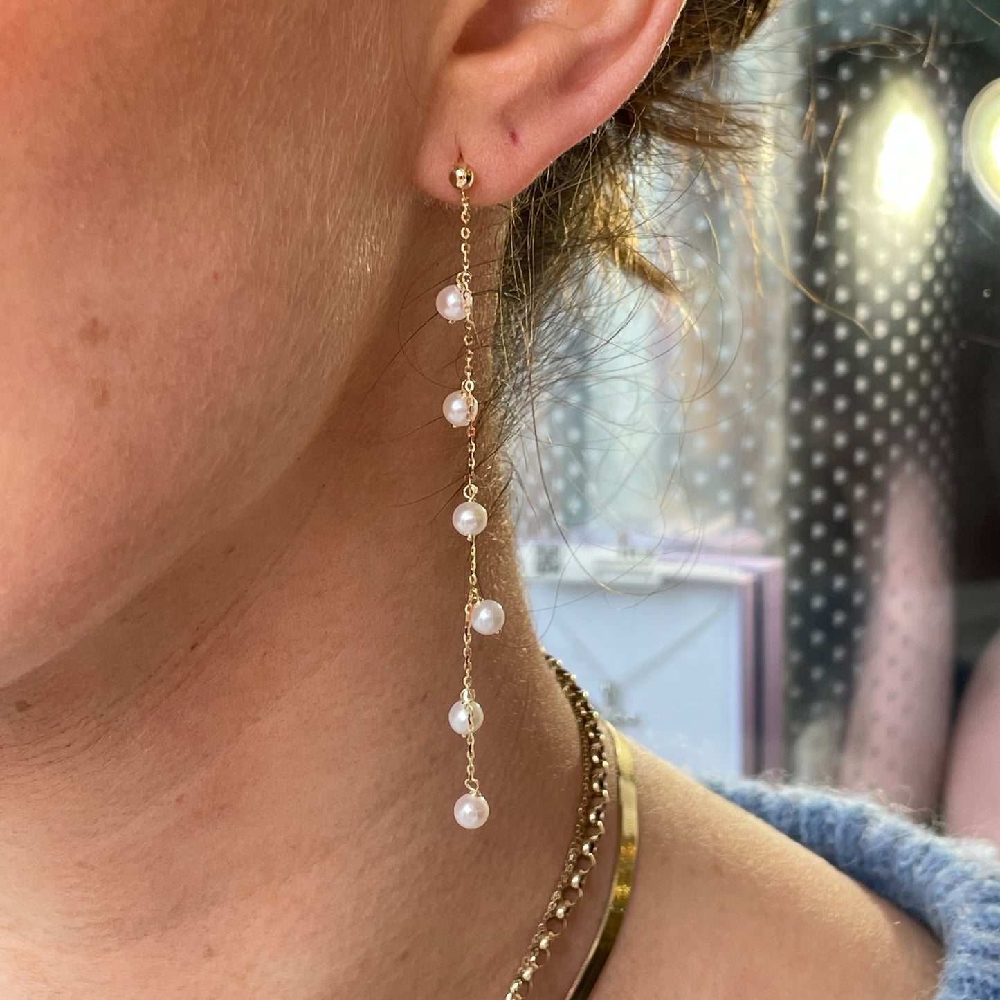 9ct gold freshwater pearl long drop earrings by Mark Milton, featuring elegant pearl strands hanging from gold hooks.