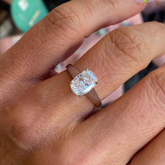 Domino platinum modified cushion solitaire engagement ring with a 2.01ct certified lab diamond, showcasing the elegant ring design.