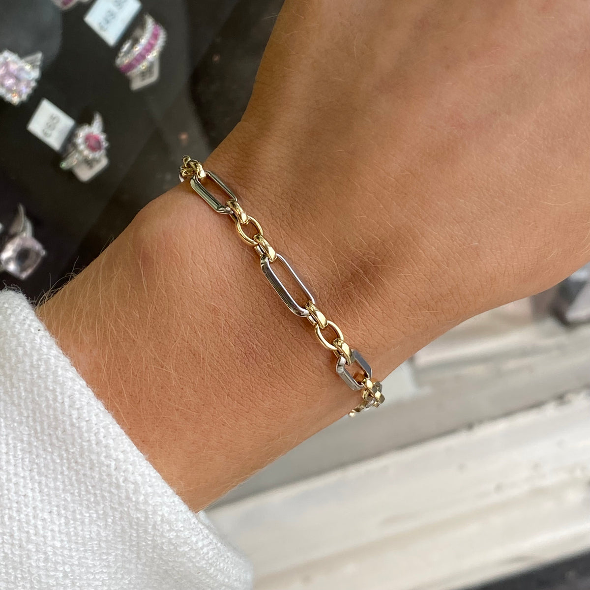9ct gold modern Figaro two-tone bracelet by Mark Milton, featuring layered gold links and a sleek clasp design.