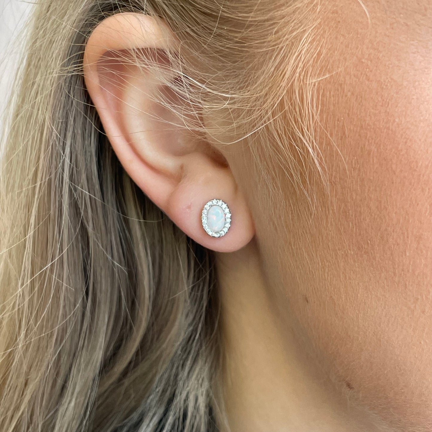 Silver CZ Opalique oval stud earrings by Insignia featuring shiny silver metal and elegant oval-shaped cubic zirconia stones.