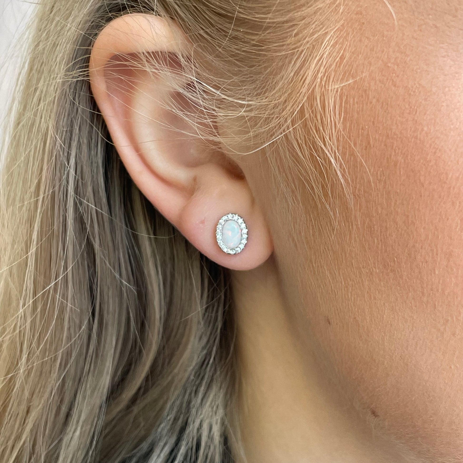 Silver CZ Opalique oval stud earrings by Insignia featuring shiny silver metal and elegant oval-shaped cubic zirconia stones.
