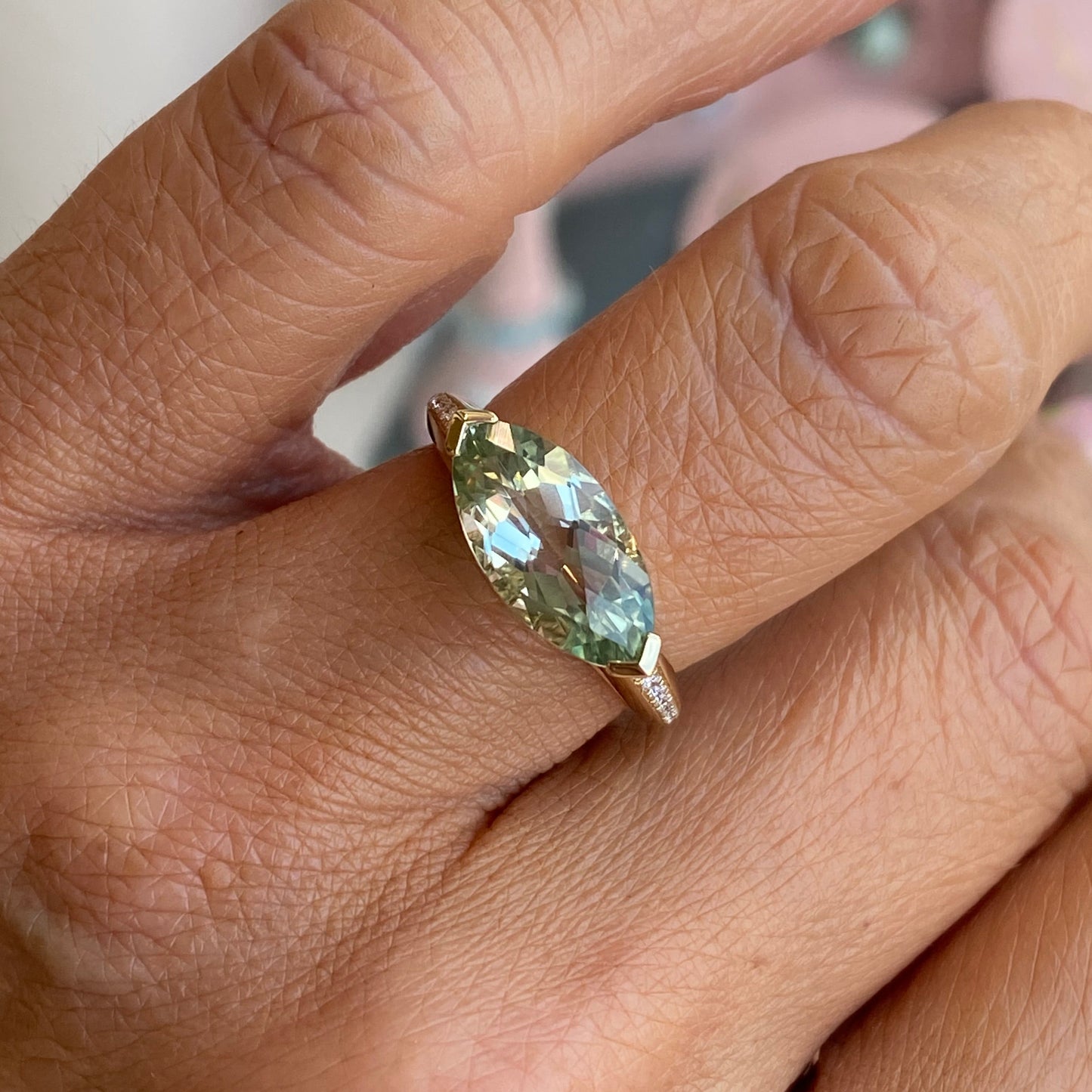 9ct gold green amethyst and diamond ring with a central green gemstone and surrounding diamonds, crafted by TCA.
