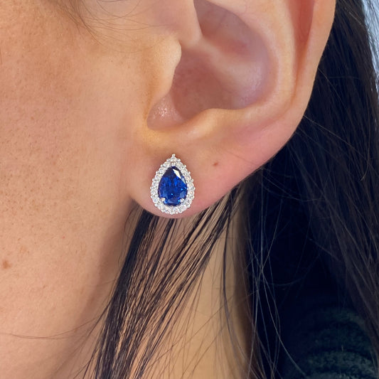 Silver Pear Halo CZ stud earrings with created sapphire accents, featuring a classic jewelry design by Insignia.