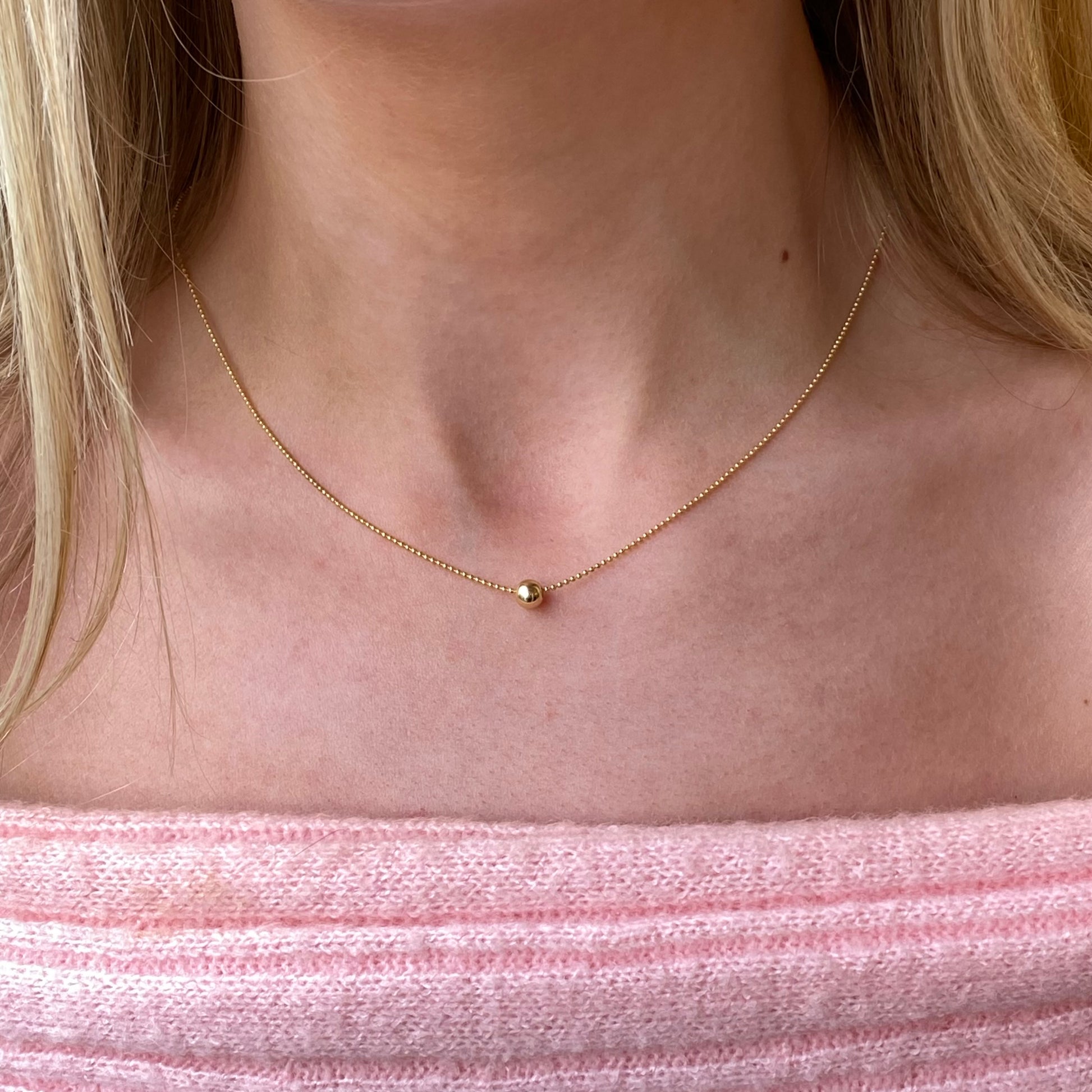 Sunshine Polka Dot Slider Necklace by Comero featuring a delicate chain and charming polka dot pendant.
