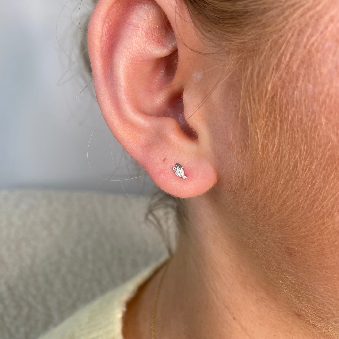 Silver double leaf stud earrings for kids by Comero, featuring delicate leaf-shaped designs on small, lightweight earrings.