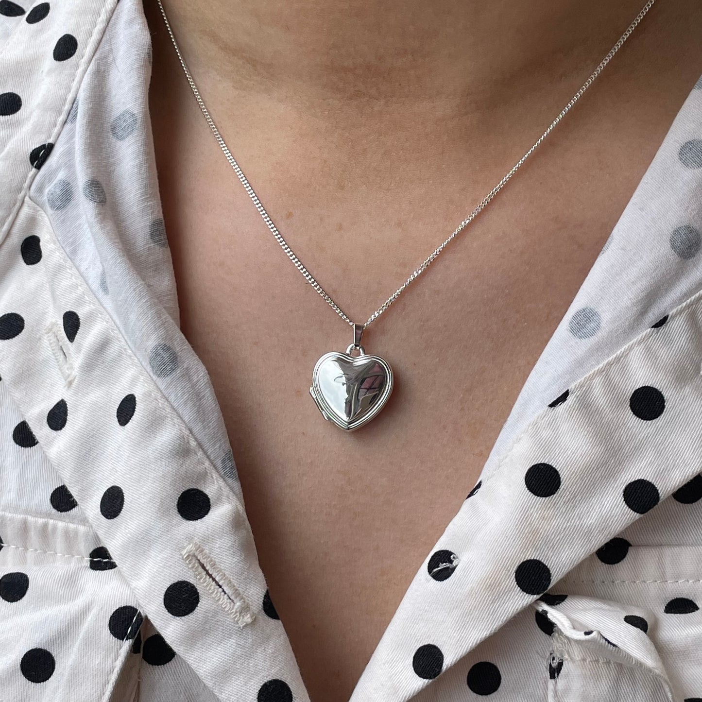 Silver stepped border heart locket necklace by Clandela featuring a detailed heart-shaped pendant with elegant border design.