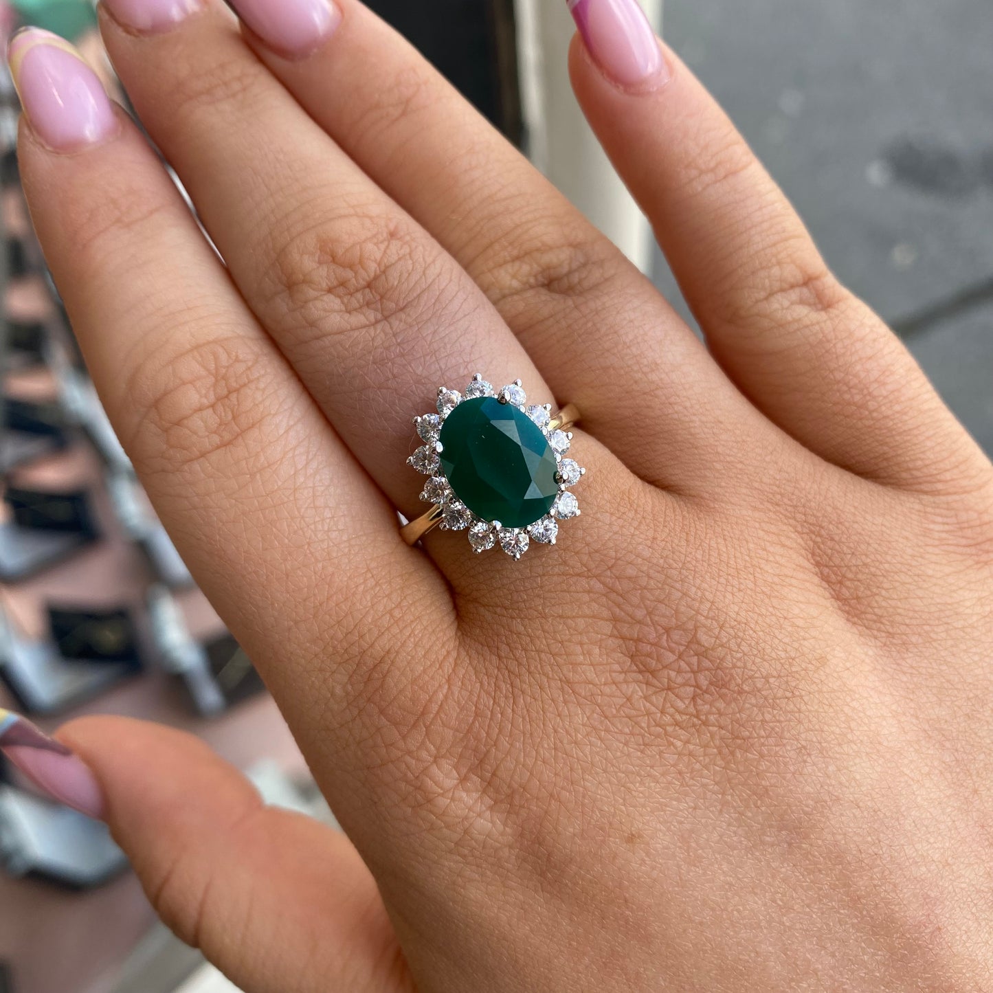 9ct gold created emerald and CZ oval cluster ring with intricate design, crafted by PJD, showcasing vibrant green stones and sparkling accents.