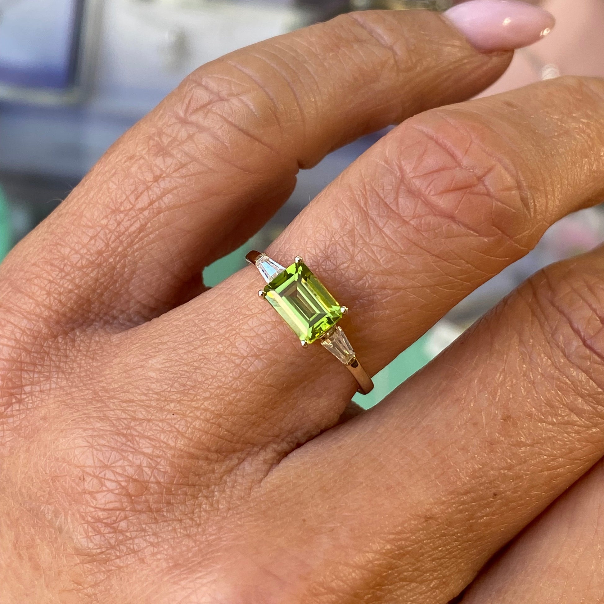 Insignia 9ct gold east-west ring with peridot gemstone and cubic zirconia accents, showcasing a stylish jewelry design.