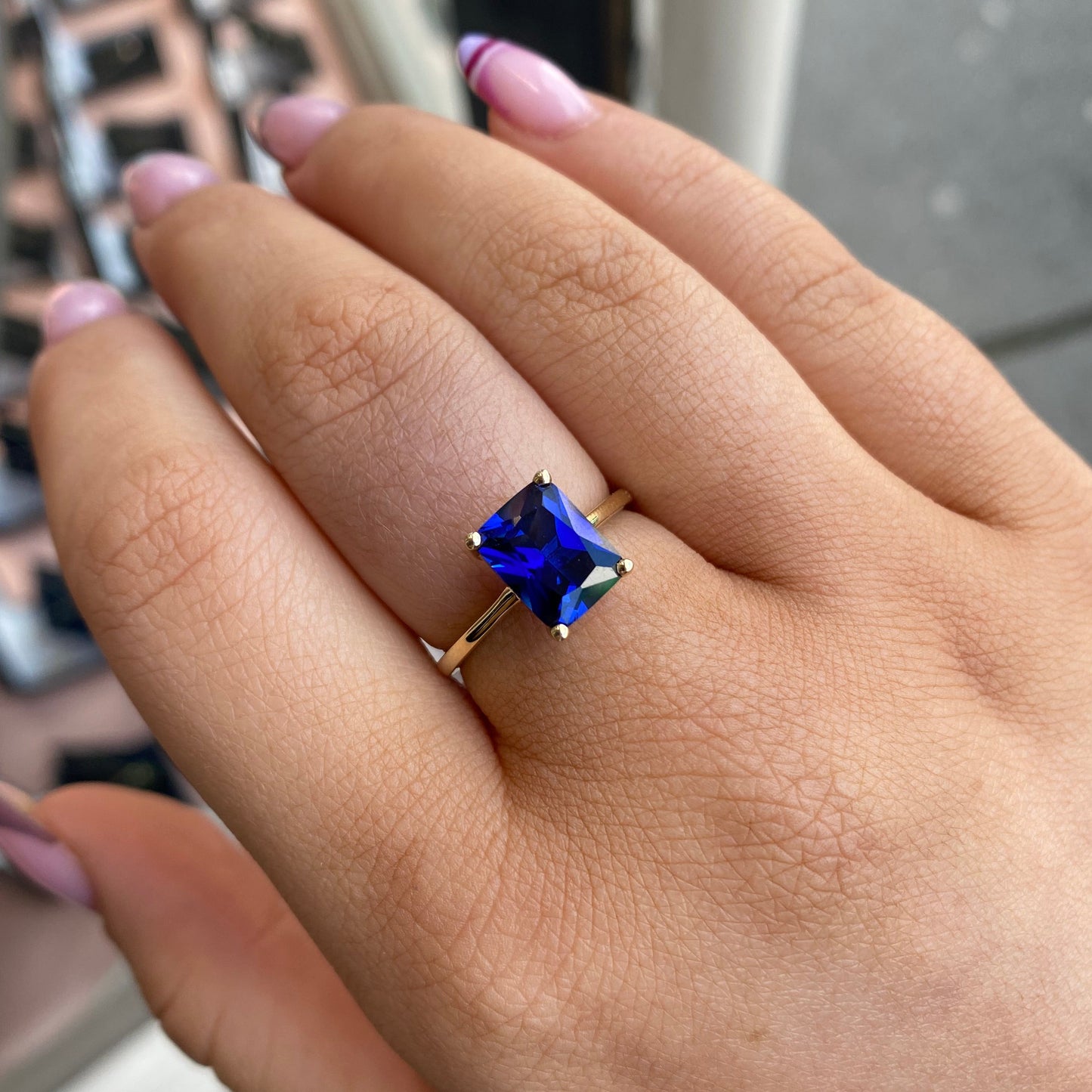 9ct gold created sapphire solitaire ring featuring a sparkling blue sapphire set in a classic gold band.