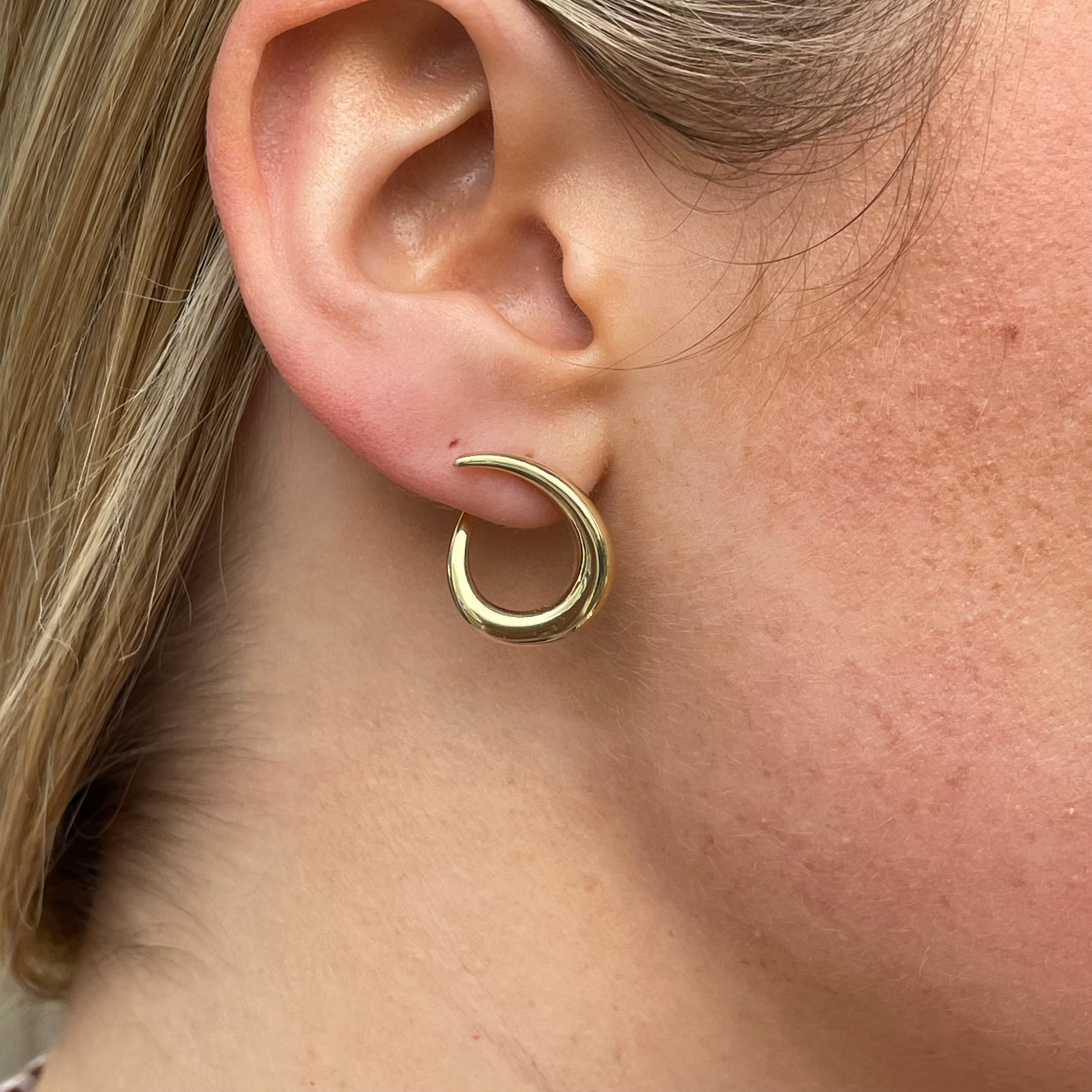 9ct gold swirl drop earrings by Mark Milton with elegant curved design and polished finish, displayed on a white background.