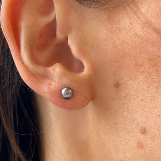 Silver 5mm freshwater pearl stud earrings in grey with a polished finish, featuring classic stud style for elegant wear.