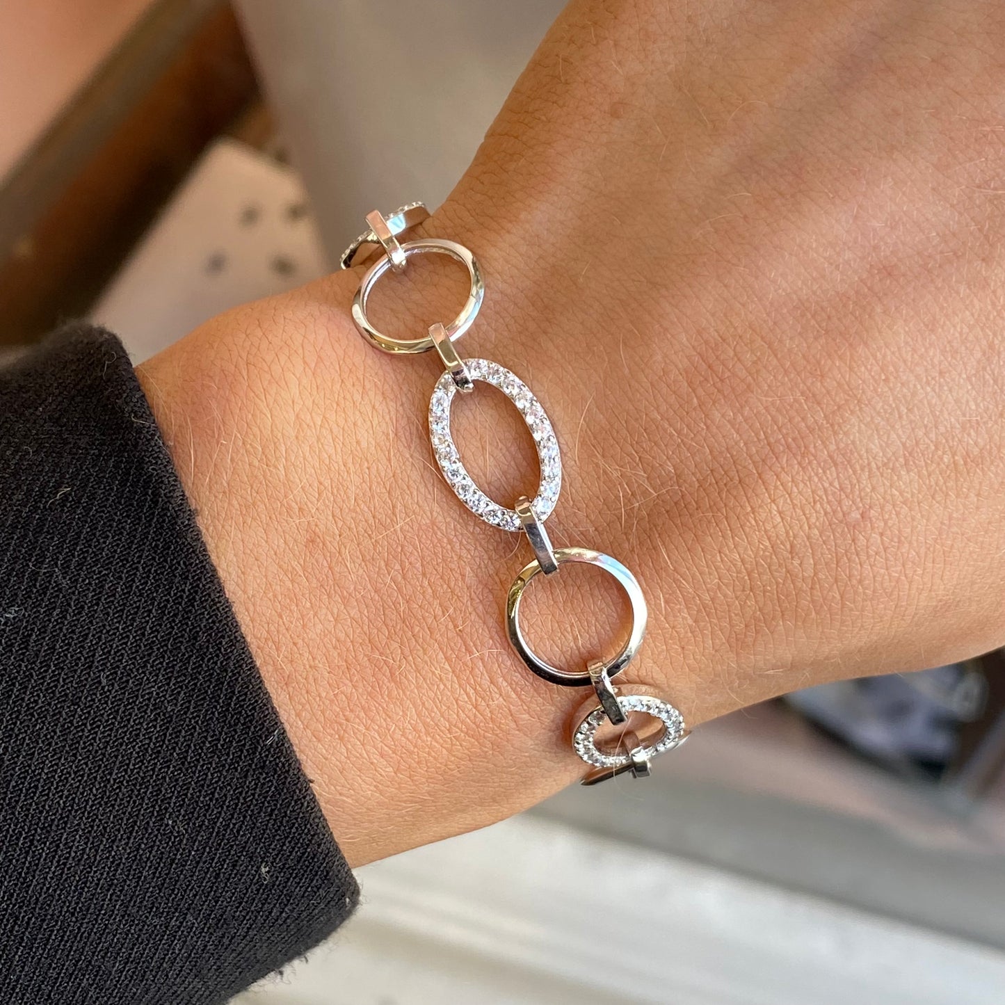 Silver CZ open oval bracelet by Insignia featuring sleek open oval links with sparkling cubic zirconia accents.