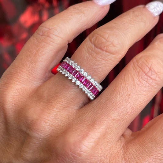 Silver spiky band ring with ruby red accents by Comero, featuring a bold, edgy design and pointed spikes on the band.