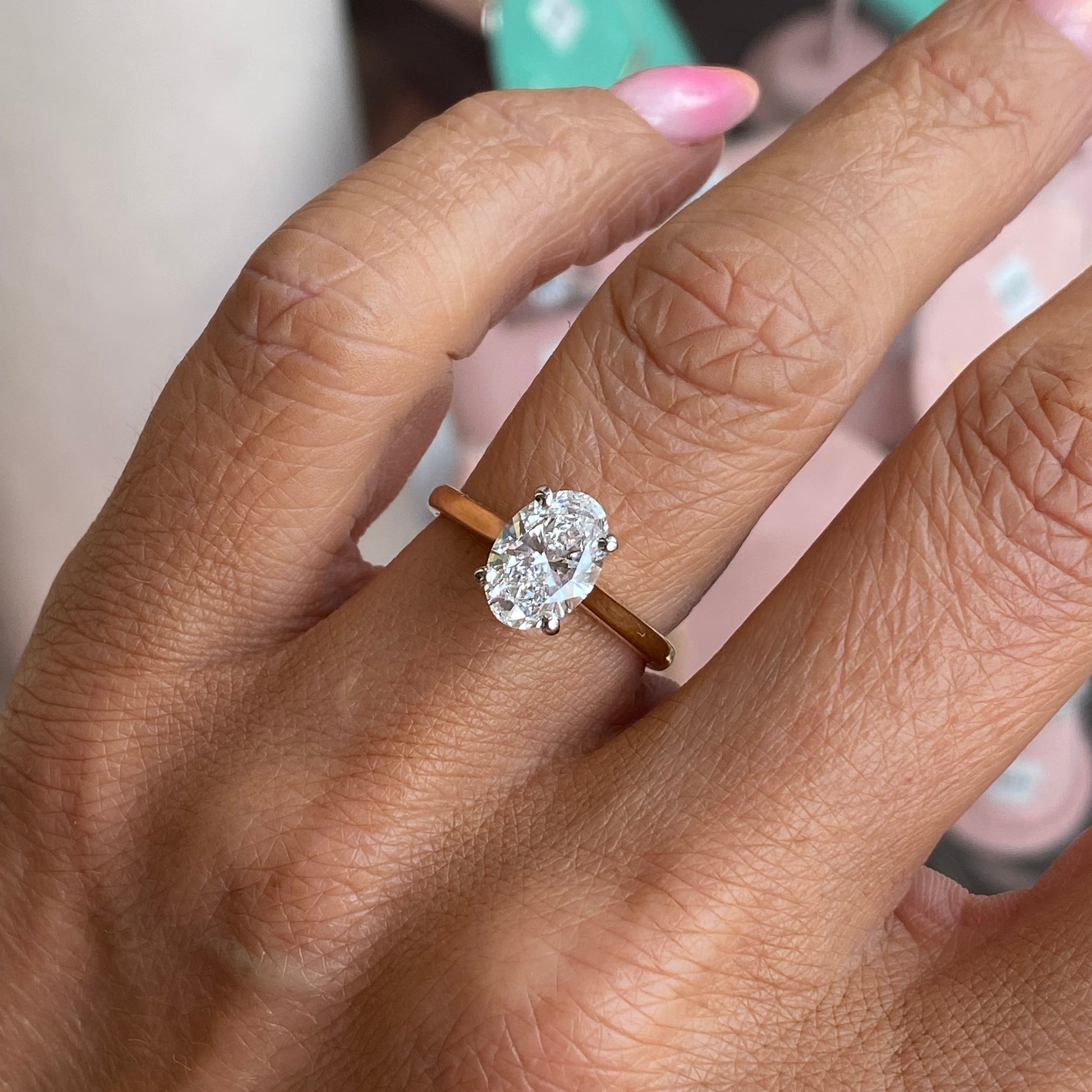 18ct gold oval solitaire engagement ring with a 1.82ct certified lab diamond, featuring a sleek design by Prima.