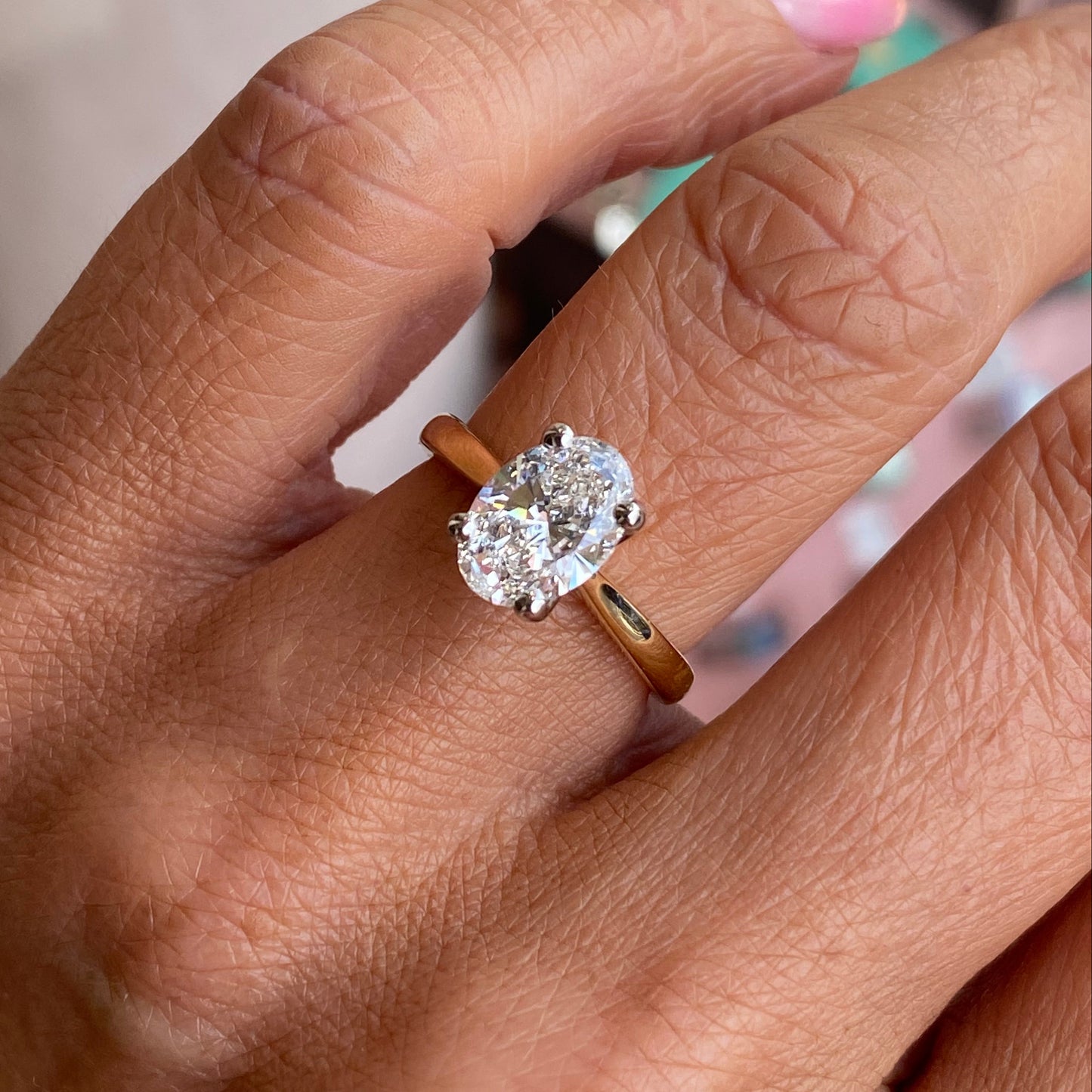 18ct gold oval solitaire engagement ring with a 1.72ct certificated diamond by Prima, showcasing the elegant design and sparkling center stone.