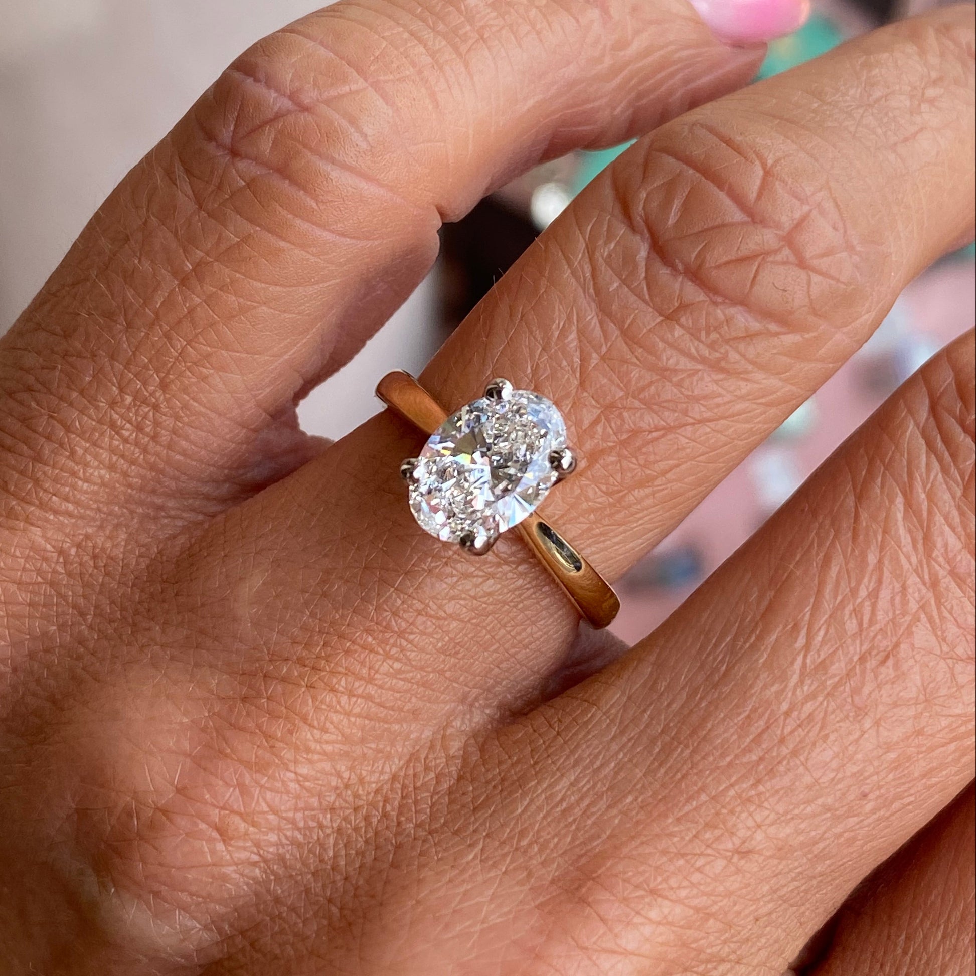18ct gold oval solitaire engagement ring with a 1.72ct certificated diamond by Prima, showcasing the elegant design and sparkling center stone.