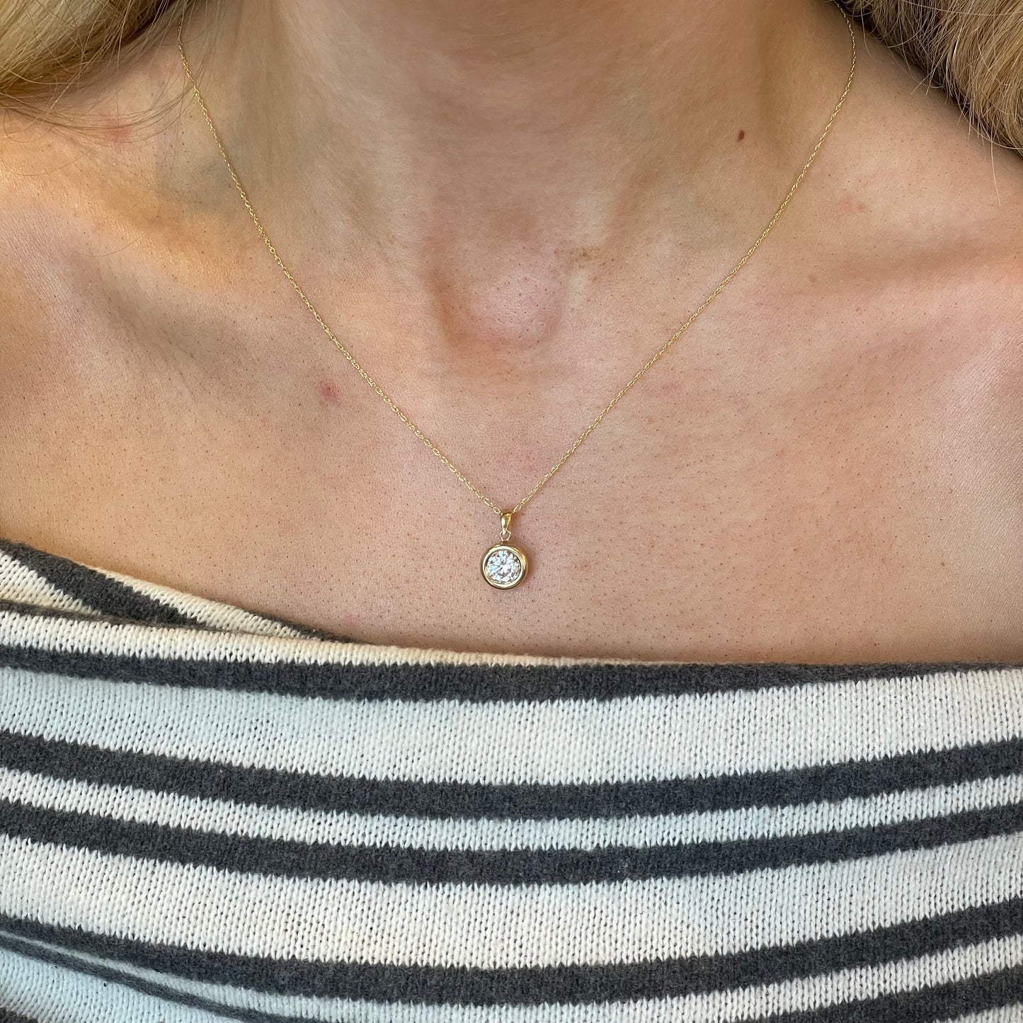 9ct gold bezel set CZ necklace with a 6mm round cubic zirconia, elegant jewelry piece by NJO.