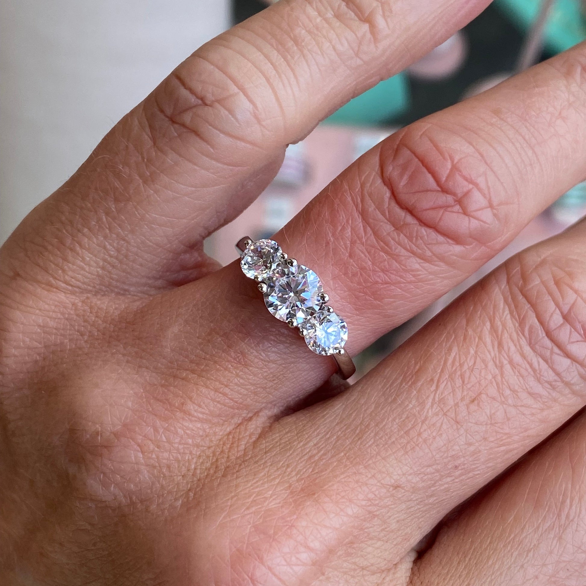 Silver CZ Trilogy Ring by Insignia showcasing a three-stone design with sparkling cubic zirconia gemstones.