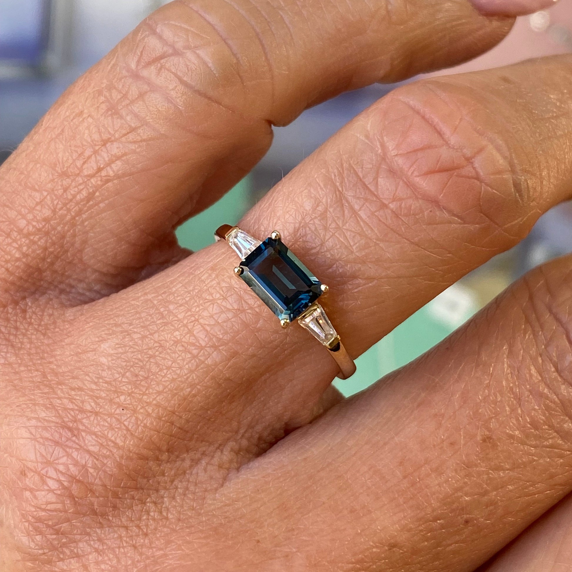 Insignia 9ct gold east-west ring featuring a London Blue Topaz and cubic zirconia accents, showcasing a sleek and elegant design.
