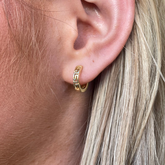 Sunshine Greek pattern huggie hoop earrings by Comero, featuring gold-tone design with intricate Greek key pattern.