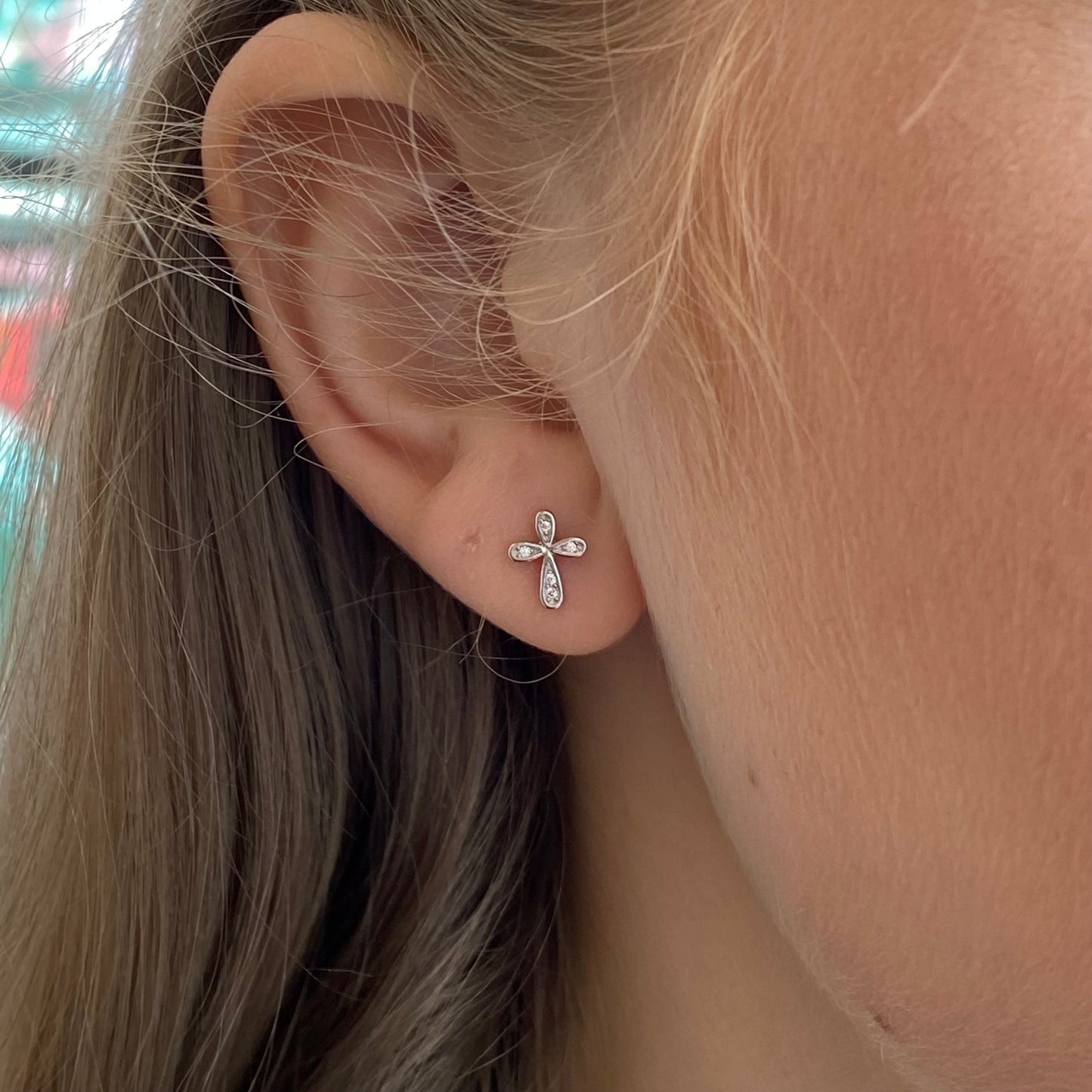 Silver CZ cross stud earrings by Insignia featuring sparkling cubic zirconia stones and a classic cross design.