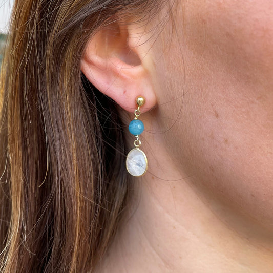 Bruno blue agate and opal drop earrings with teardrop-shaped stones hanging from silver hooks.