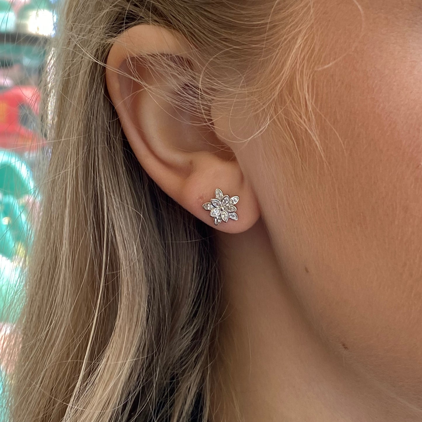 Silver CZ Camelia Stud Earrings by Insignia featuring flower-shaped design with sparkling cubic zirconia stones.