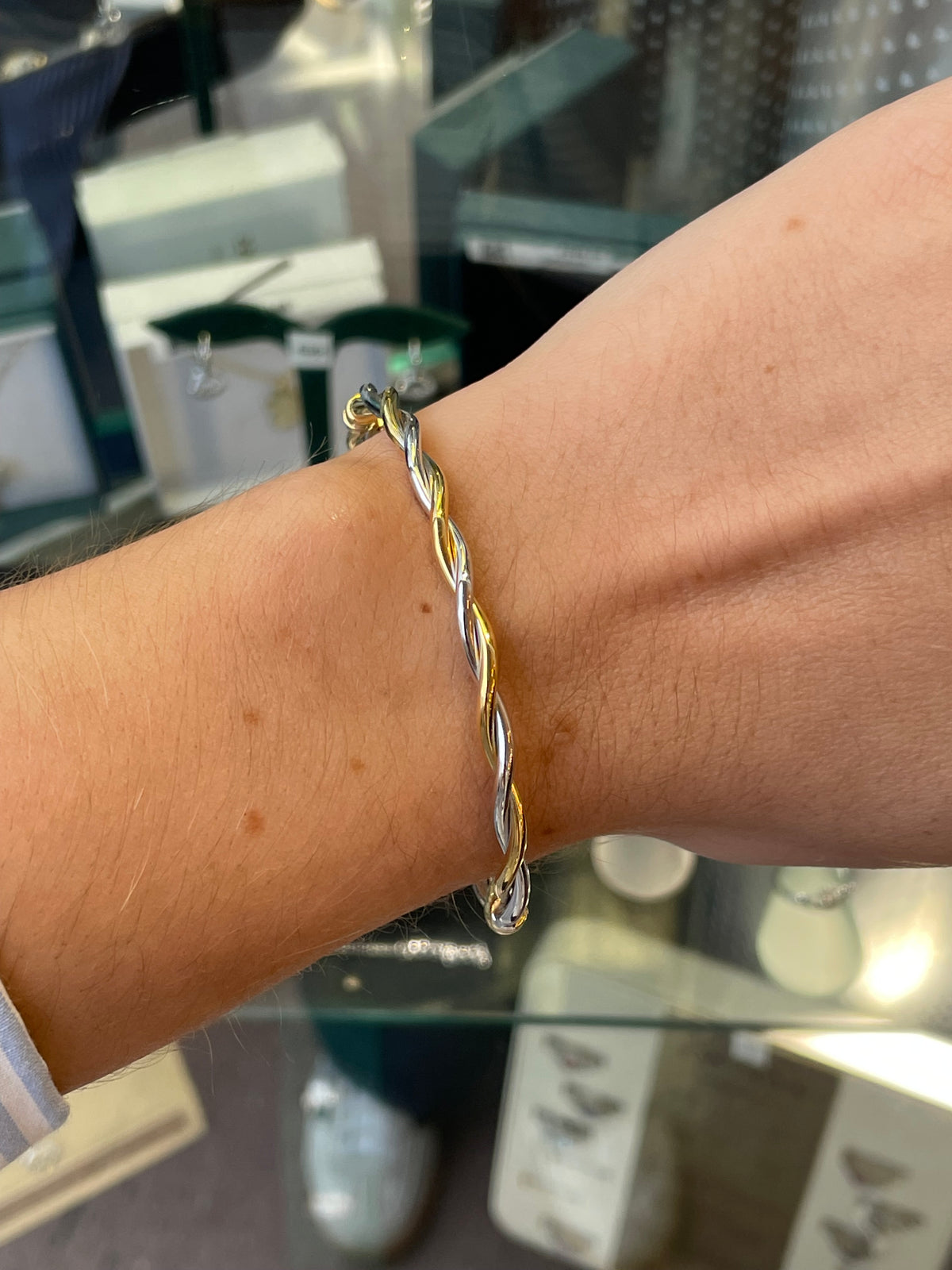 Stubbs 9ct gold two-tone twist bangle featuring intertwined gold and silver design, classic jewelry accessory for women.