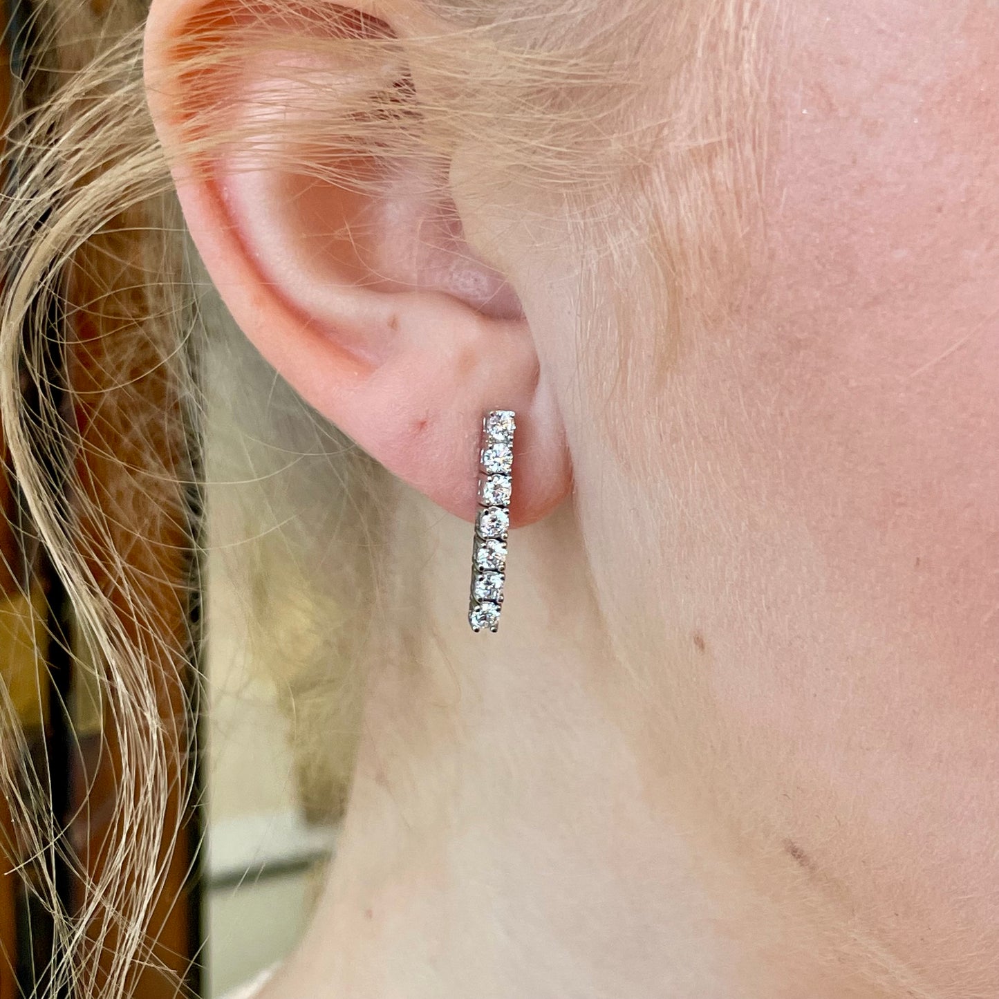 Silver graduated CZ tennis earrings by Comero featuring sparkling cubic zirconia stones in a sleek tennis earring design.