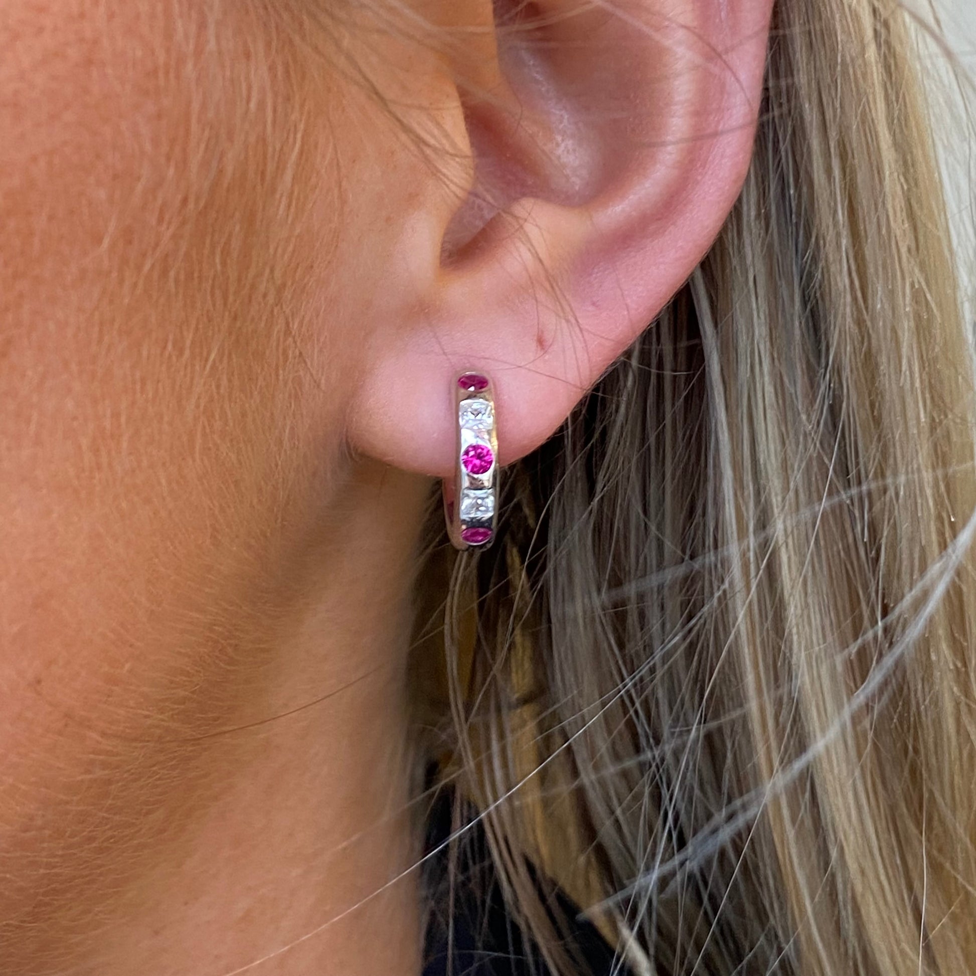 Silver red CZ hoop earrings by Comero featuring sparkling cubic zirconia stones and a sleek hoop design.