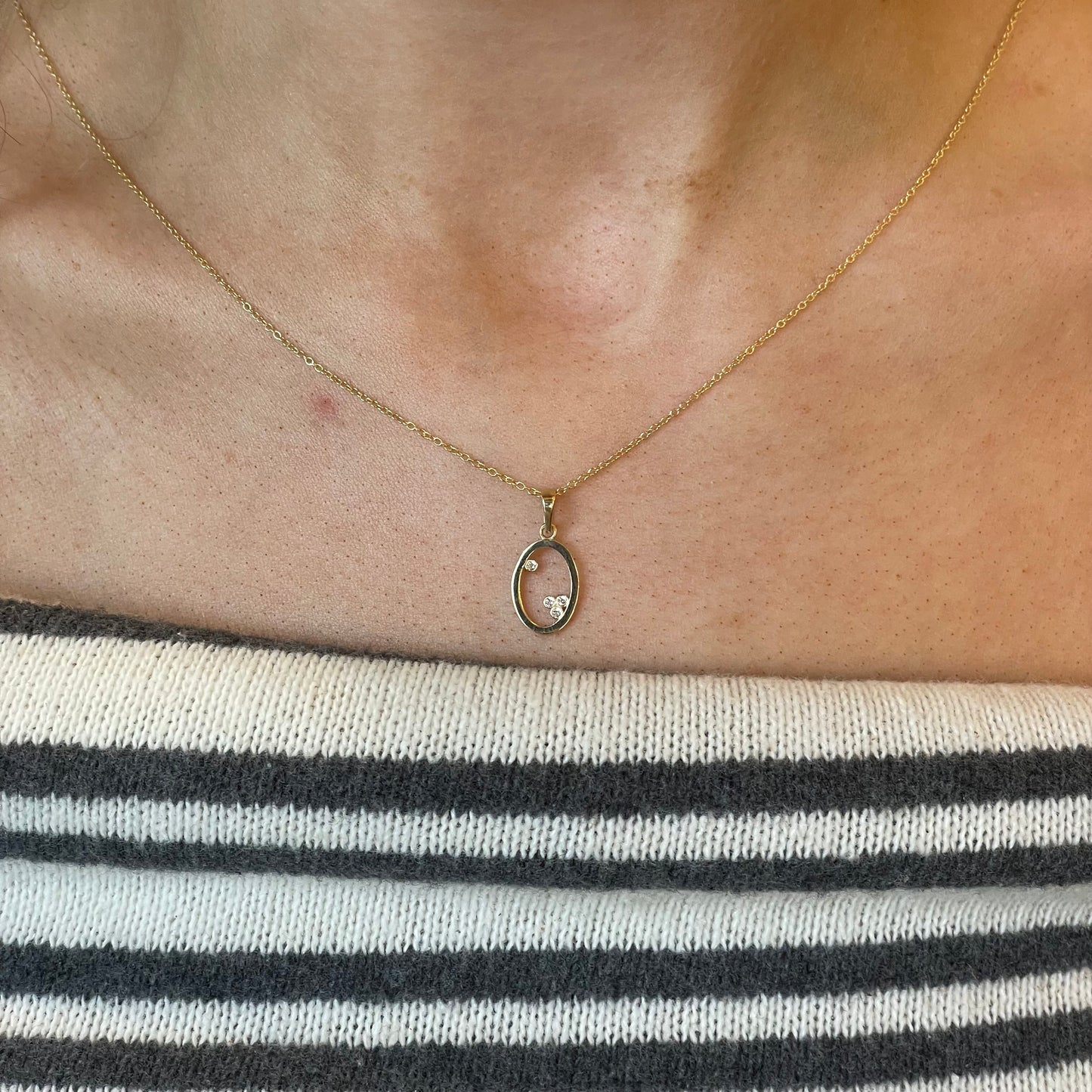 9ct gold open oval CZ necklace featuring a pretty design, crafted by THC, with a delicate and elegant appearance.