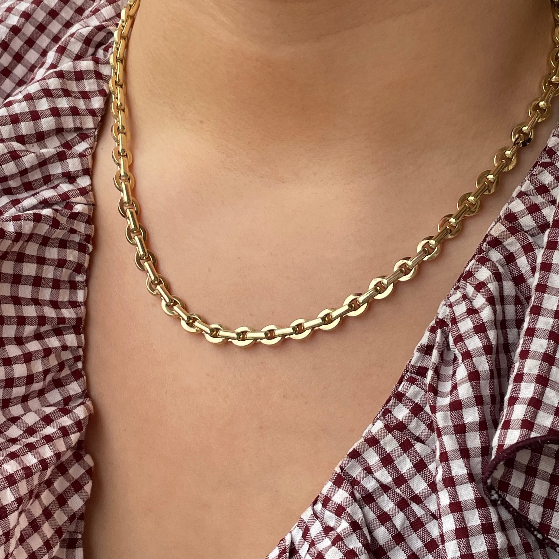 9ct gold chunky contemporary link necklace by Mark Milton, showing large interconnected gold links on a plain background.