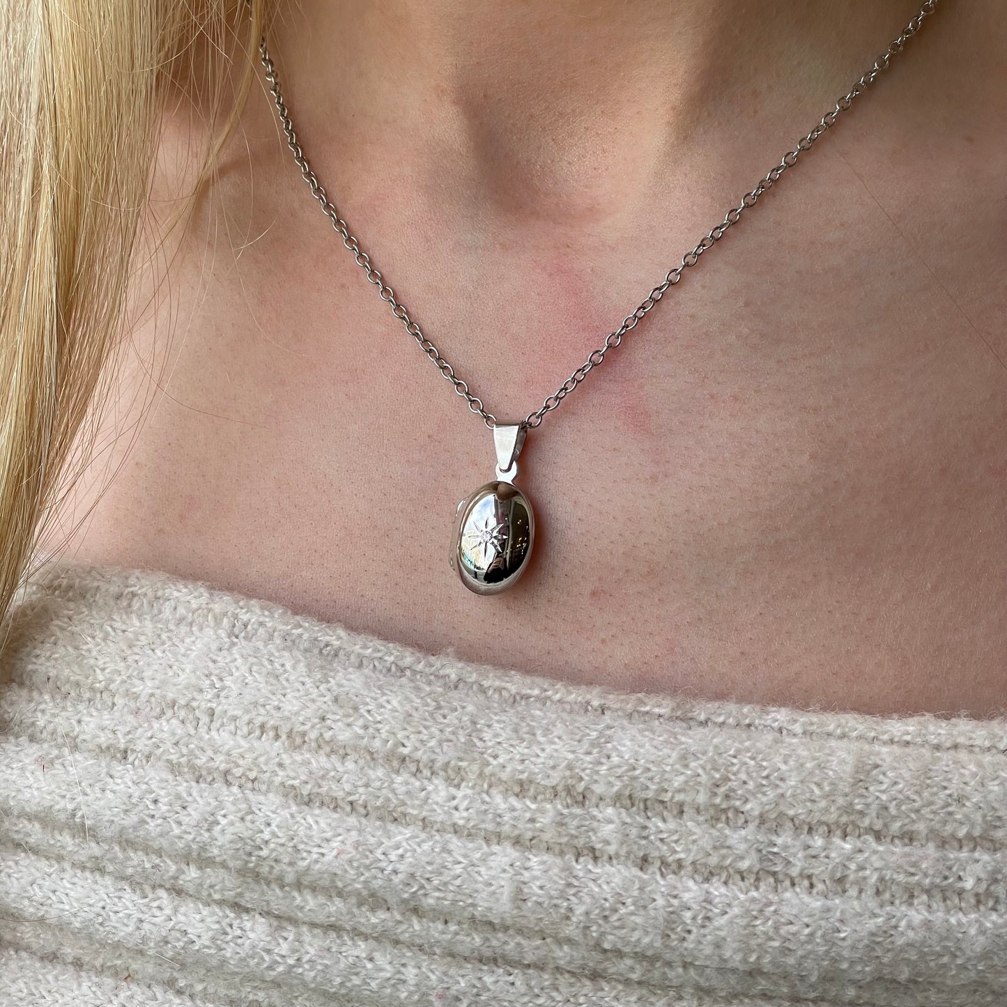 Silver CZ oval locket necklace with chain, featuring a polished pendant and delicate chain from Insignia.