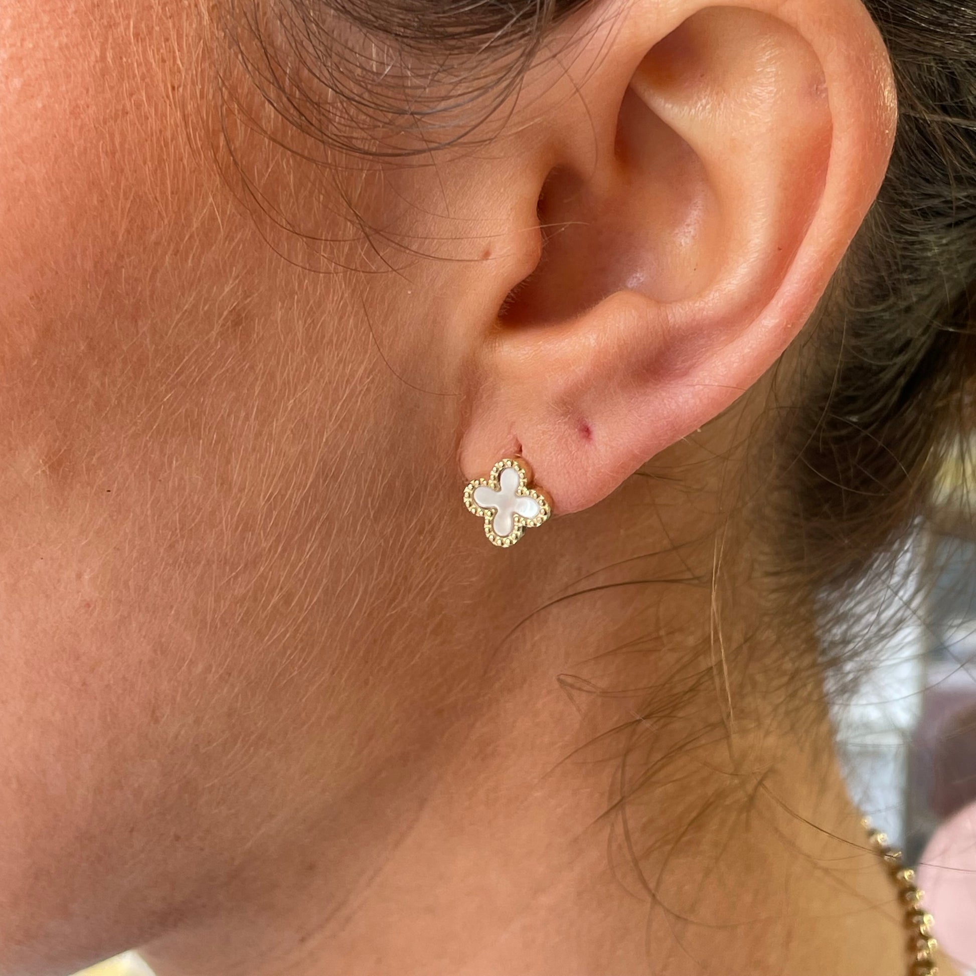 9ct gold mother of pearl quatrefoil stud earrings by Mark Milton, featuring polished mother of pearl in a gold quatrefoil design.