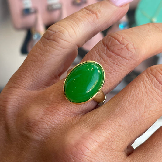 Bruno green jade oval ring with smooth polished gemstone set in a silver band, close-up view of the jewelry piece.