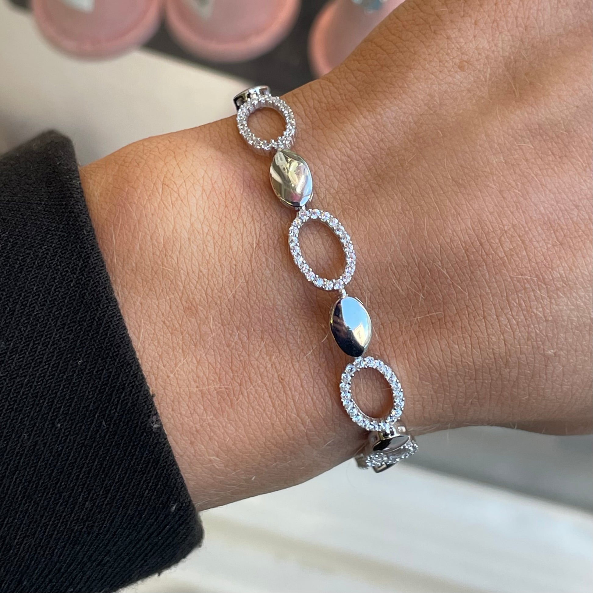 Silver CZ open oval bracelet by Insignia featuring sparkling cubic zirconia accents and sleek open oval design.
