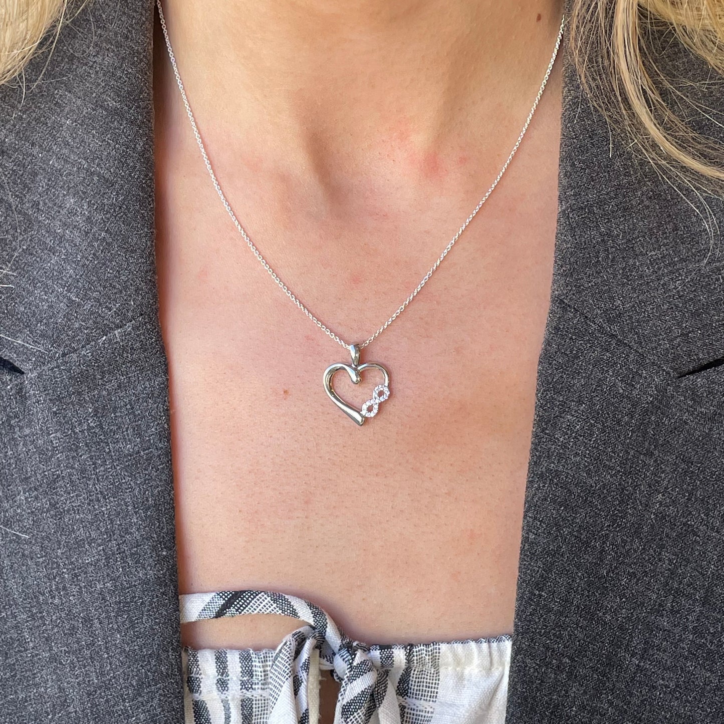 Silver CZ Love Forever pendant necklace by Comero, featuring an elegant design on an 18-inch chain.