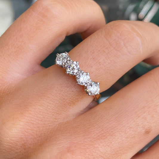 18ct gold four-stone loop diamond eternity ring with 1.10ct diamonds from FEU, showcasing the elegant design and sparkling gemstones.
