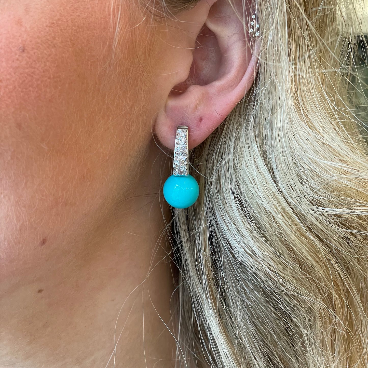 Silver CZ and 12mm faux turquoise hoop earrings by Comero, featuring sparkling stones and vibrant turquoise accents