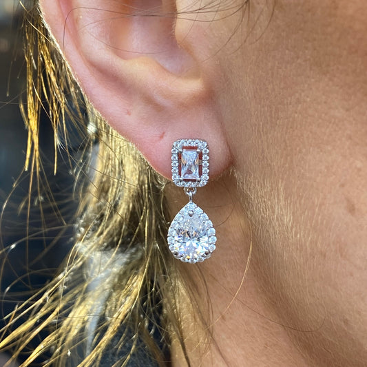 Silver Pear and Radiant Halo CZ drop earrings by Comero featuring pear-shaped and halo-design cubic zirconia stones.