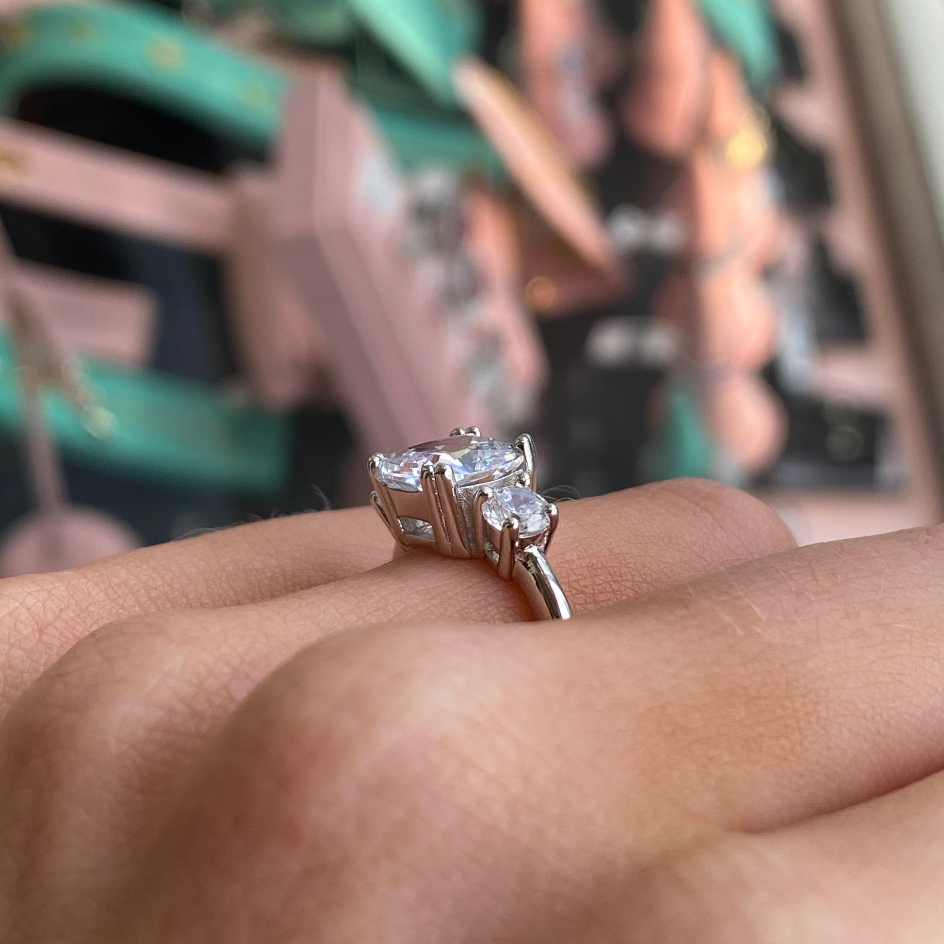 Silver Cushion Trilogy CZ ring by THC featuring a three-stone design with sparkling cubic zirconia on a sleek band.