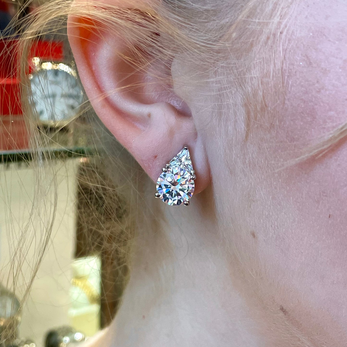 Silver CZ clip-on earrings by Comero featuring sparkling cubic zirconia stones and sleek silver design.