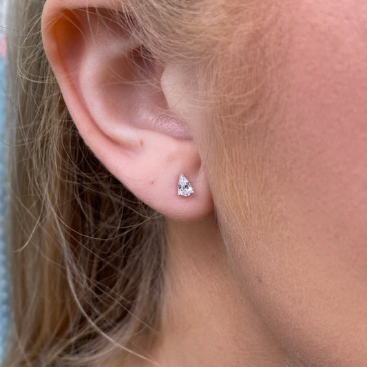Silver pear cut CZ stud earrings by CME featuring sparkling gemstone accents on classic earring posts.