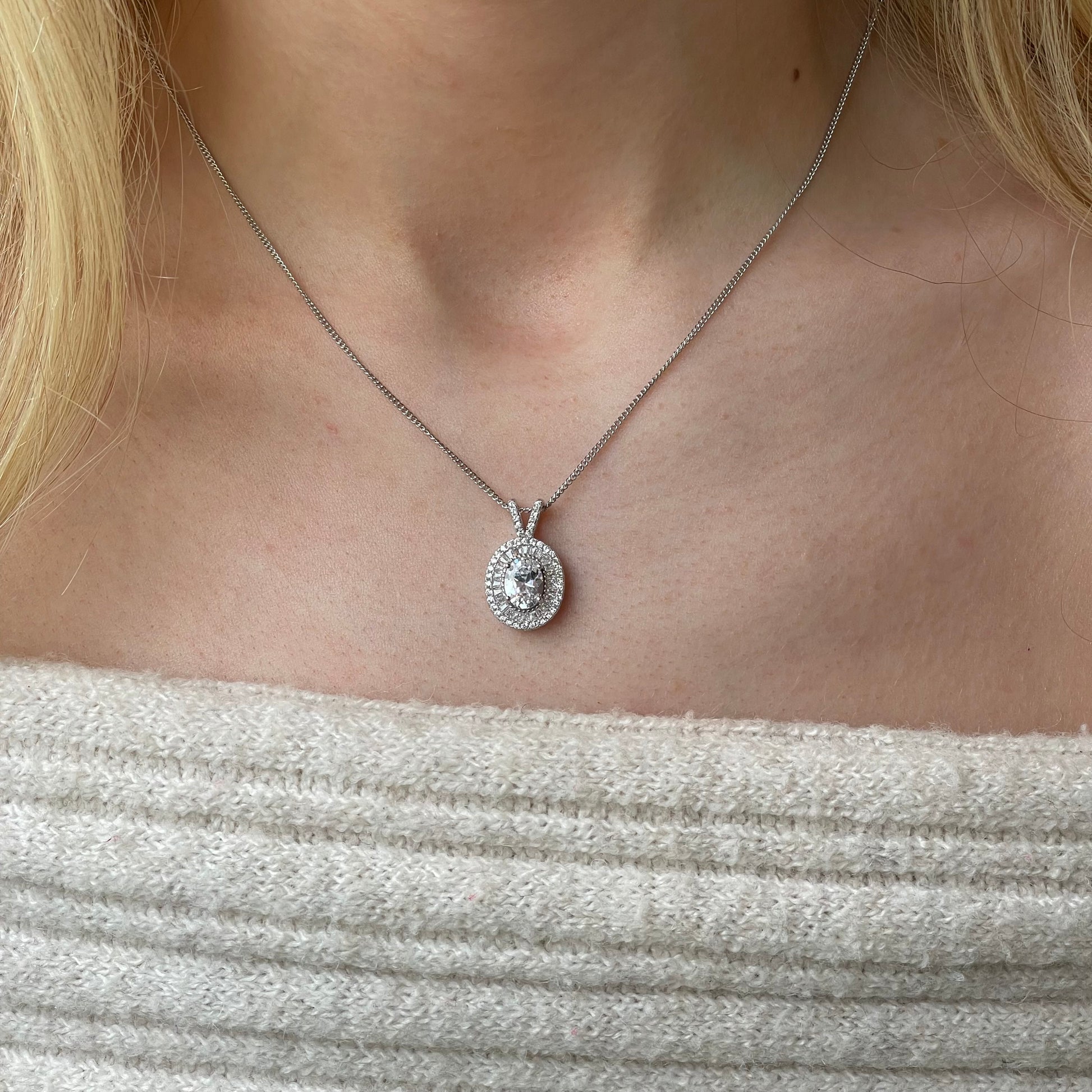 Silver oval CZ halo necklace by Insignia featuring a central oval gemstone surrounded by a sparkling halo design.