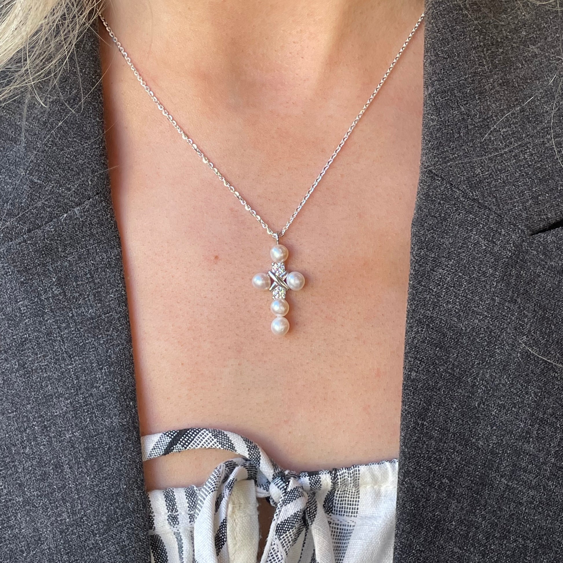 Silver CZ and 5mm freshwater pearl cross necklace with 18-inch chain from Comero, featuring a pendant with sparkling stones and pearls.