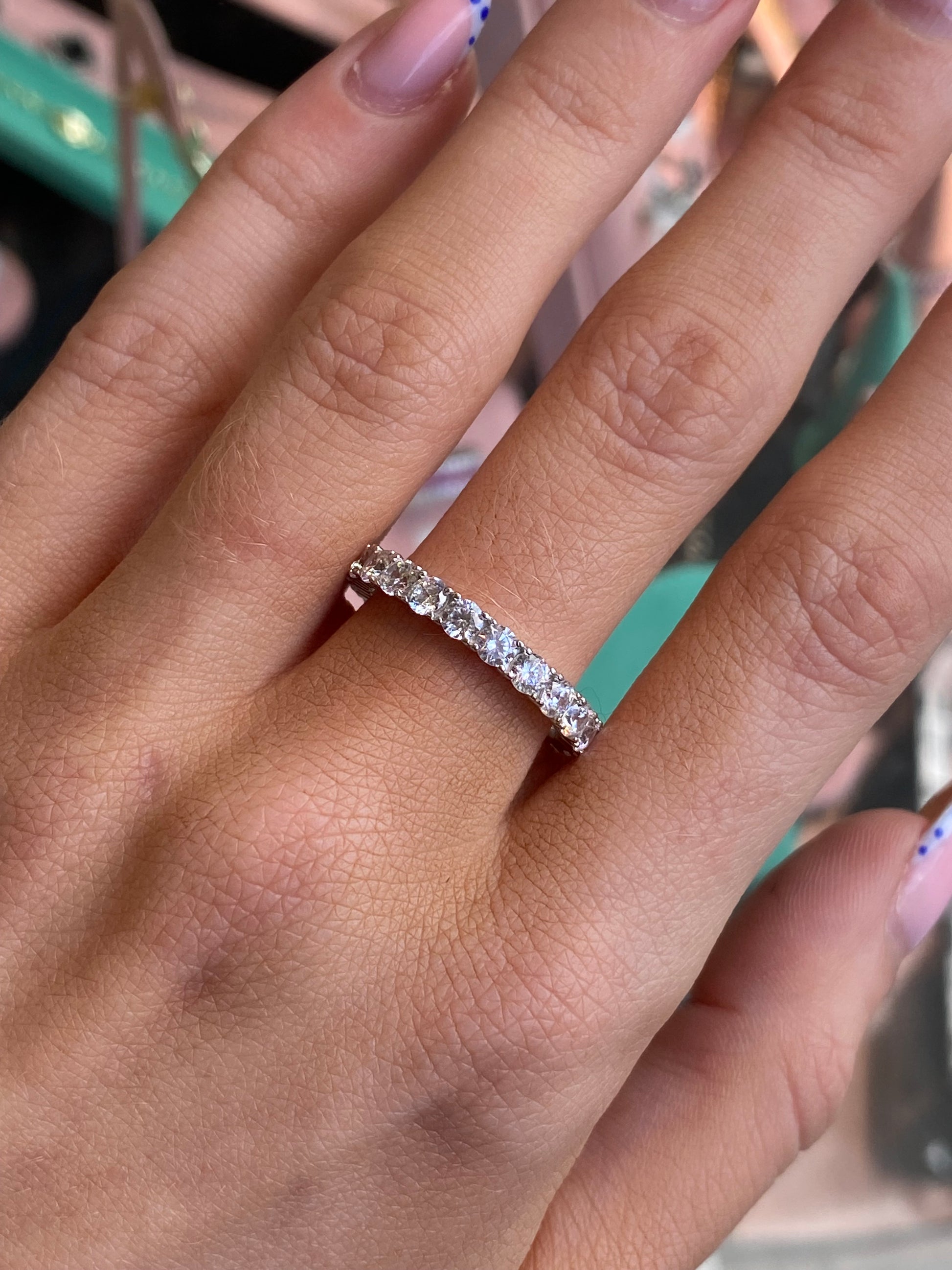 Silver Trisha ring by Comero featuring a sleek band and minimalist design, displayed on a neutral background.