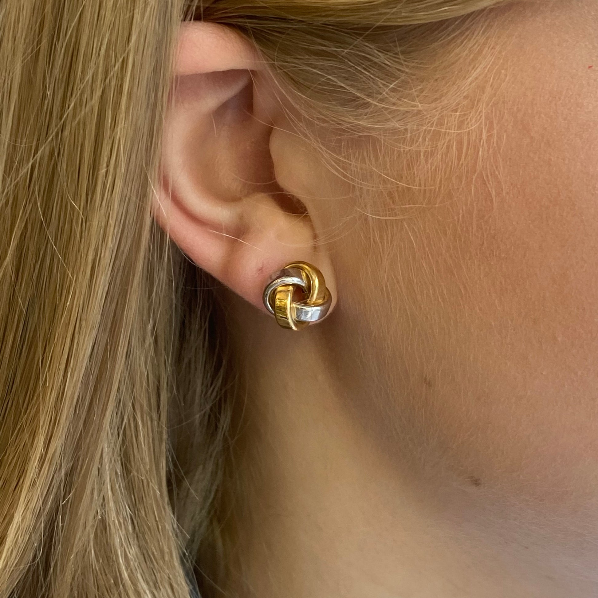 Stubbs 9ct gold three-tone chunky knot stud earrings, showing close-up of gold, rose, and yellow tones with knot design.