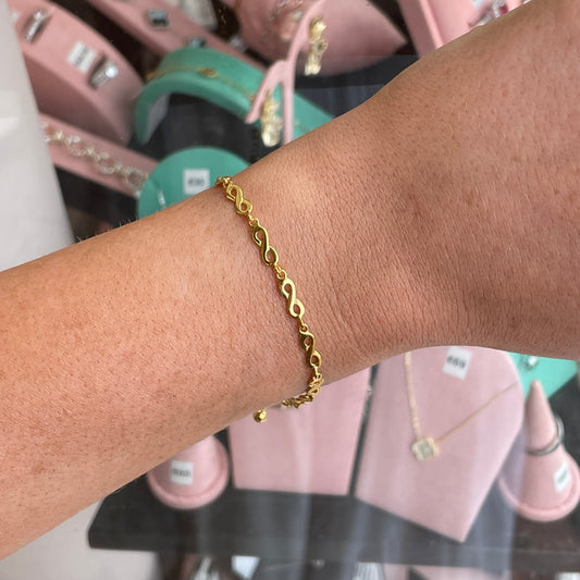 CME Sunshine Infinity bracelet featuring a gold infinity symbol on a delicate chain, perfect for elegant jewelry styling.