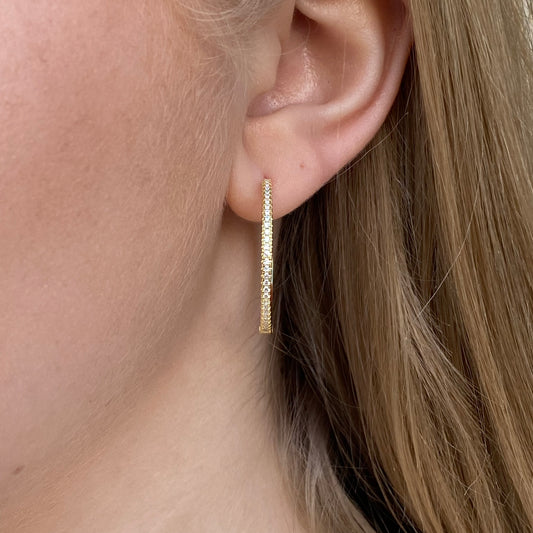 Sunshine Skinny CZ Hoop Earrings by Comero, 30mm gold-tone earrings with sparkling cubic zirconia and a sleek, modern design